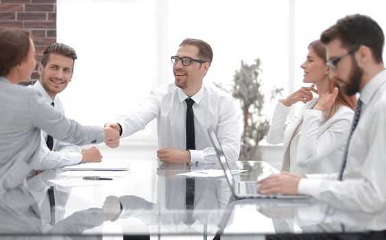 Manager shaking hands with a young business woman.the concept of cooperation