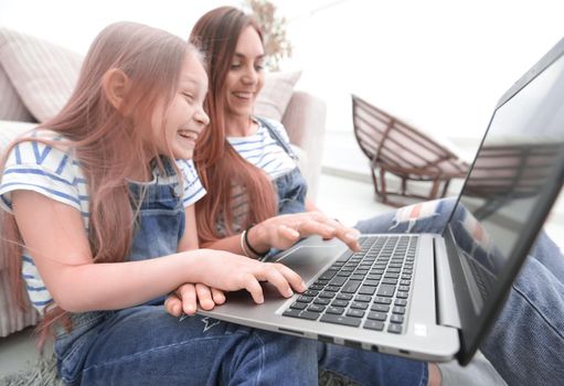 childhood, parenting and technology concept - happy mother with adorable little girl with laptop