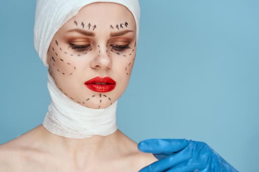 woman posing in blue gloves red lips surgery facial rejuvenation studio lifestyle. High quality photo
