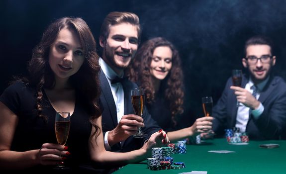 poker players with a glass of wine,sitting at the table in the club