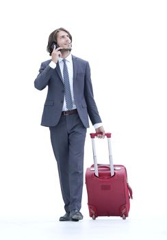 successful businessman with travel suitcase talking on the phone. photo with copy space