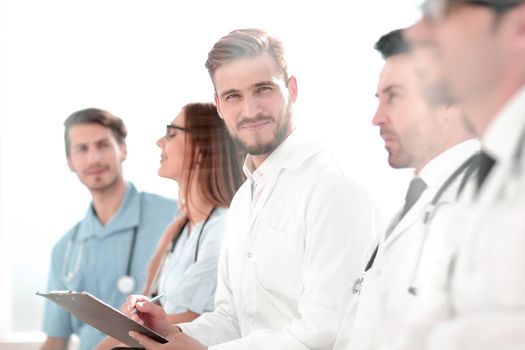 Portrait of successful medical workers listening to the lecture and making notes