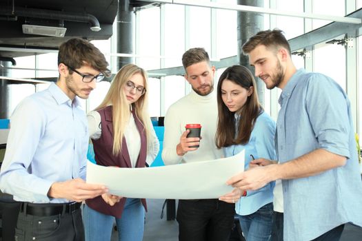 Group of young business people and designers in smart casual wear. They working on new project