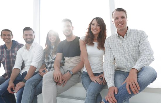 Group of young creative people sitting on chairs in waiting room