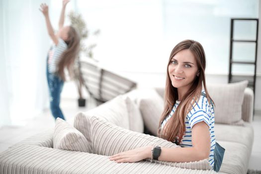 young woman sitting on sofa in new living room.photo with copy space