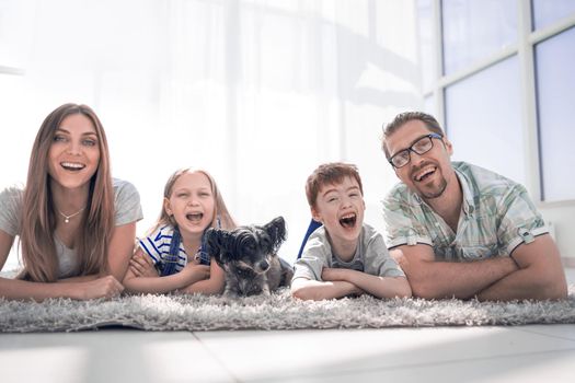 happy family with two children lying in the new living room.photo with copy space