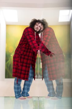 portrait of young man in bathrobe enjoying free time at home