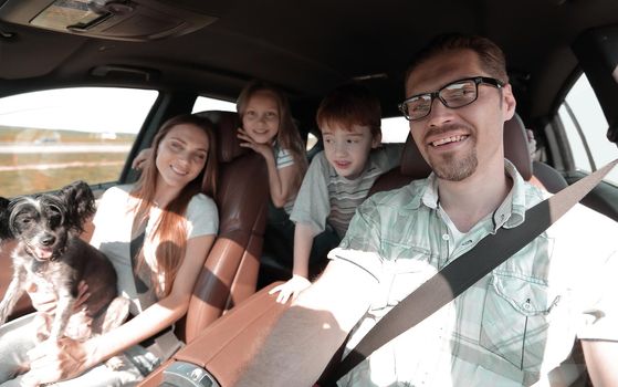 close-knit family with two children traveling in the car.the concept of freedom and travel