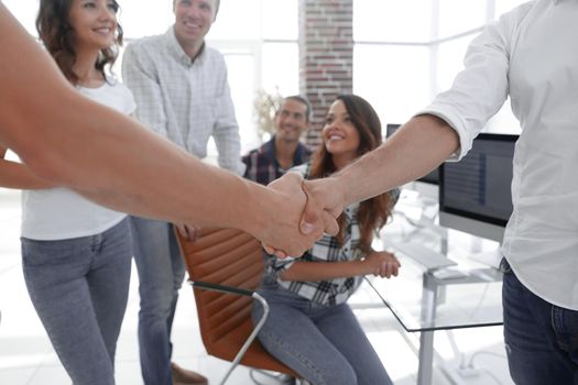 closeup of handshake of business partners on the background of the office