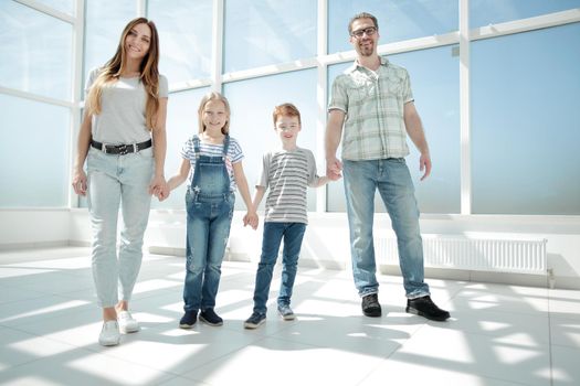 parents with small children standing in the new house .photo with copy space
