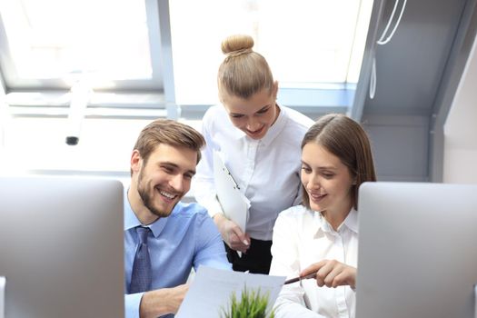 startup business team on meeting in modern bright office interior brainstorming, working on tablet and PC computers