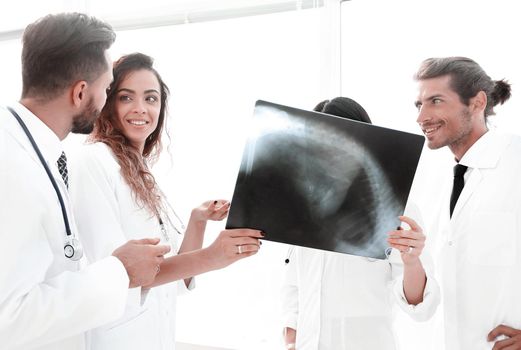 group of medical workers looking at patient's x-ray film