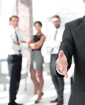 closeup. businessman holding out hand for a handshake.the concept of partnership