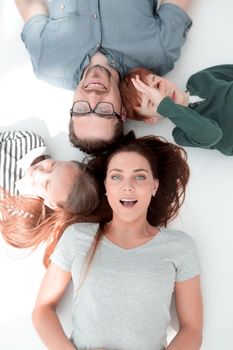 top view. happy parents with children to relax by lying on the floor. the concept of family happiness