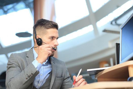 Smiling friendly handsome young male call centre operator