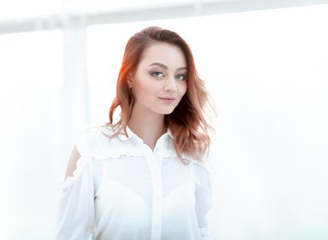 serious young business woman wearing white shirt, looking to you camera, isolated white background.