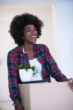 Beautiful African  American girl moving in the new apartment