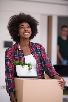 Beautiful African  American girl moving in the new apartment