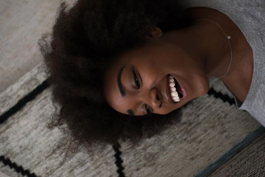 Close up face of a beautiful african american woman  lying on carpet