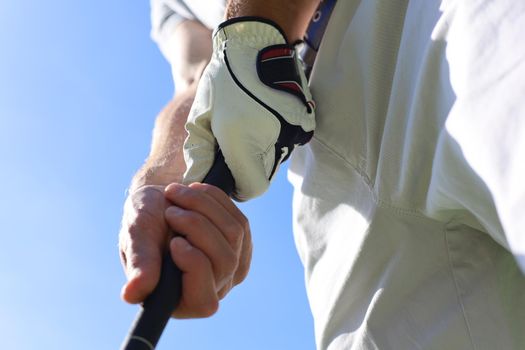 Golfer wearing a golf holding a putter