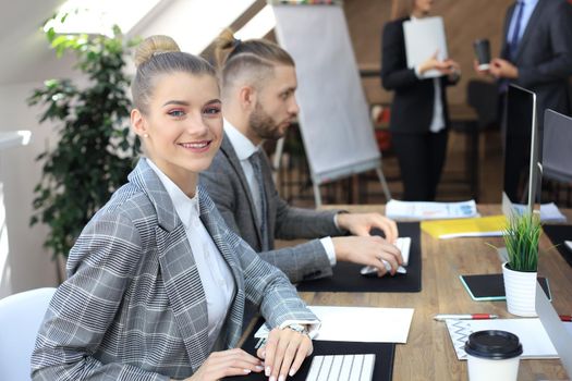 business woman with her staff, people group in background at modern bright office indoors