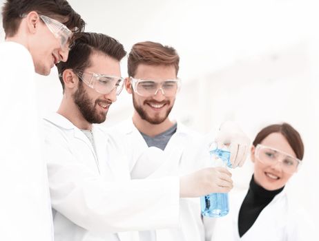 group of scientists working with chemicals on a bright background
