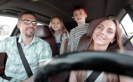 young parents go in the car .travel concept