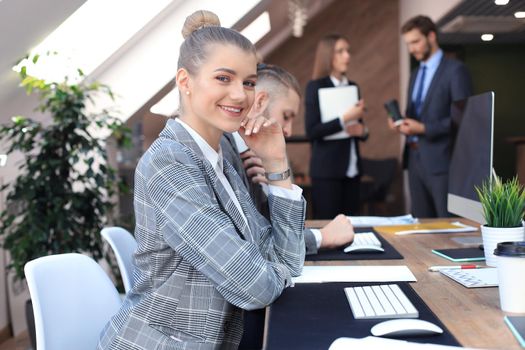 business woman with her staff, people group in background at modern bright office indoors