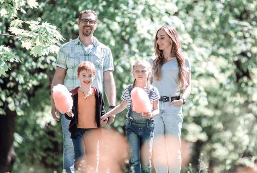 portrait of a young family on the background of the Park.the concept of family entertainment