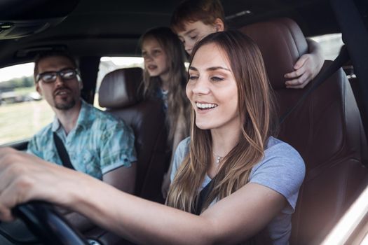 close up. a young family with children traveling in the car.family holiday concept