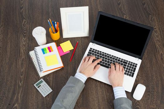 businessman works at the computer, view from above on the workplace