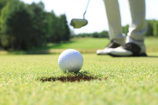 Golf club and ball. Preparing to shot