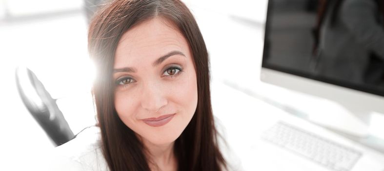 close up.confident business woman with glasses looking at the camera