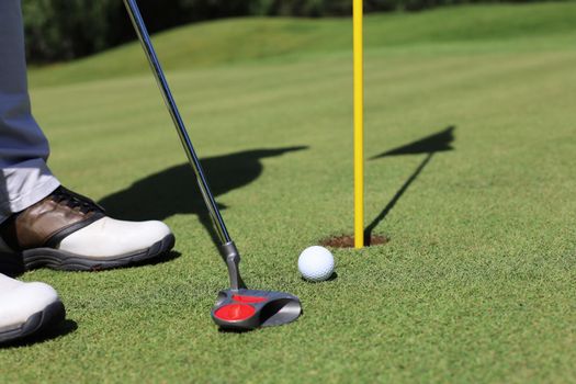 Golf club and ball. Preparing to shot