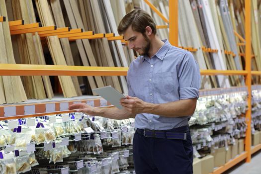 Manager use his tablet for online checking products available