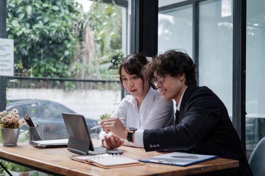 University asian students learning language using digital tablet and internet, working project together. Exam preparation. Online education concept. team of coworkers brainstorming. Meeting. Teamwork.