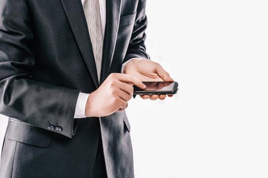 close up. businessman typing SMS on smartphone.people and technology