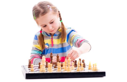 Cute little girl playing chess isolated on a white background