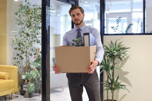 Dismissed worker going from the office with his office supplies
