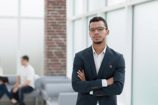young businessman on the background of a modern office. photo with copy space