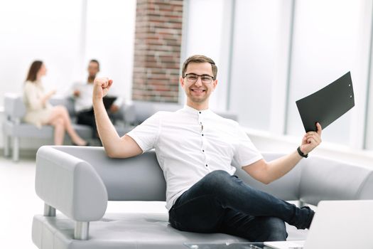 happy businessman sitting in the lobby of the Bank . business concept