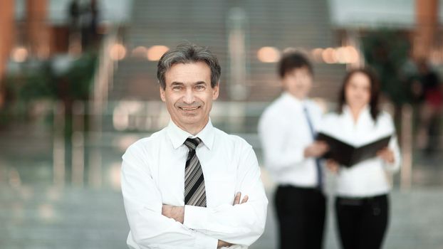 serious businessman on the background of business team. business concept