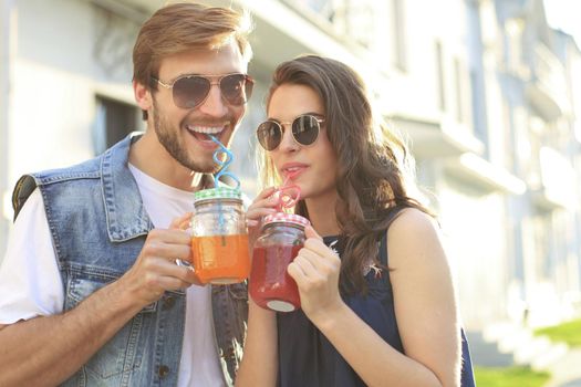 Beautiful young couple in love walking outdoors at the city street