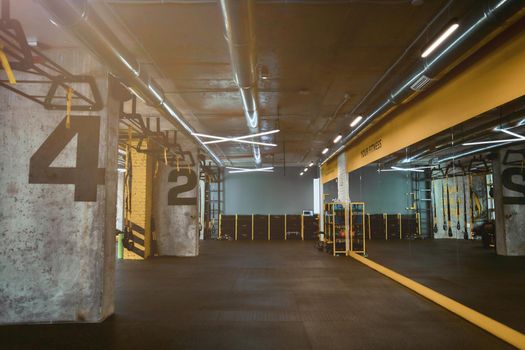 Modern empty crossfit gym or fitness studio. Sport concept, health club interior