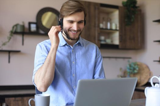 Freelance operator talking with headsets and consulting clients from home office