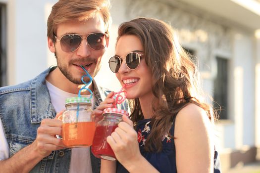 Beautiful young couple in love walking outdoors at the city street