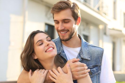 Beautiful young couple in love walking outdoors at the city street