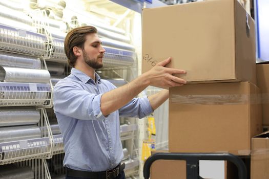 Portrait of a smiling warehouse keeper at work