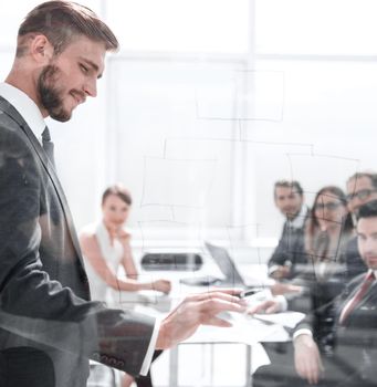 Focused caucasian business people meeting in boardroom behind glass.