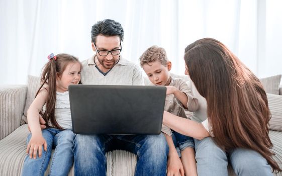 modern family looking at the laptop screen. people and technology